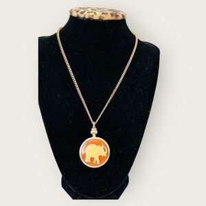 Vintage orange celluloid elephant pendant gold tone